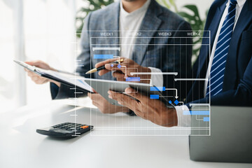 Project manager working and update tasks with milestones progress planning and Gantt chart scheduling diagram.business tram working at office.