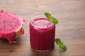Delicious dragon fruit or pitahaya smoothie and fresh fruits with mint leaves
