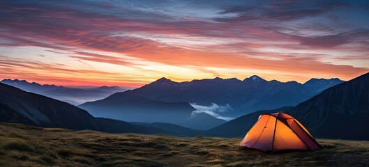 Sunrise serenity. Camping amidst mountain beauty. Mountains retreat. Tenting in nature embrace. Hiking adventure. Tenting under colorful sunset sky
