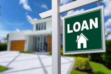 LOAN sign against a house. Close-up.