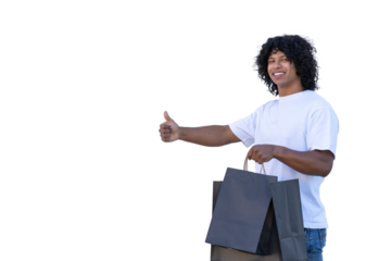 young latin man holding black shopping bags and giving thumbs up