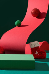A lovely wool sock decorated with sparkling baubles. Rectangle podium in green color with blank...