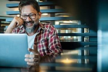 One adult man working on laptop in cafe bar with wireless internet connection. People and online...