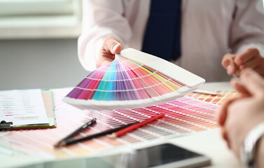 Employee refueling cartridge service holds magnifying glass in hand. Color print of pantone...