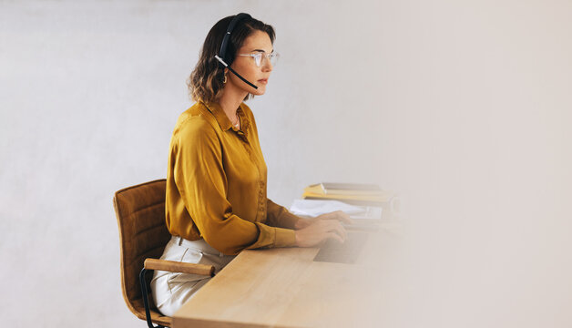 Customer support agent handling incoming calls in a telecommunications office