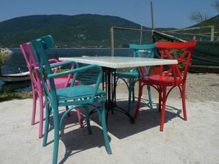 Colorful wooden chairs with view on sea