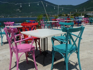 Colorful wooden chairs with view on sea