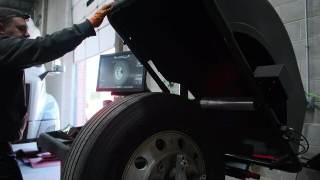 Wheel balancing or repair and change car truck tire at auto service garage or workshop