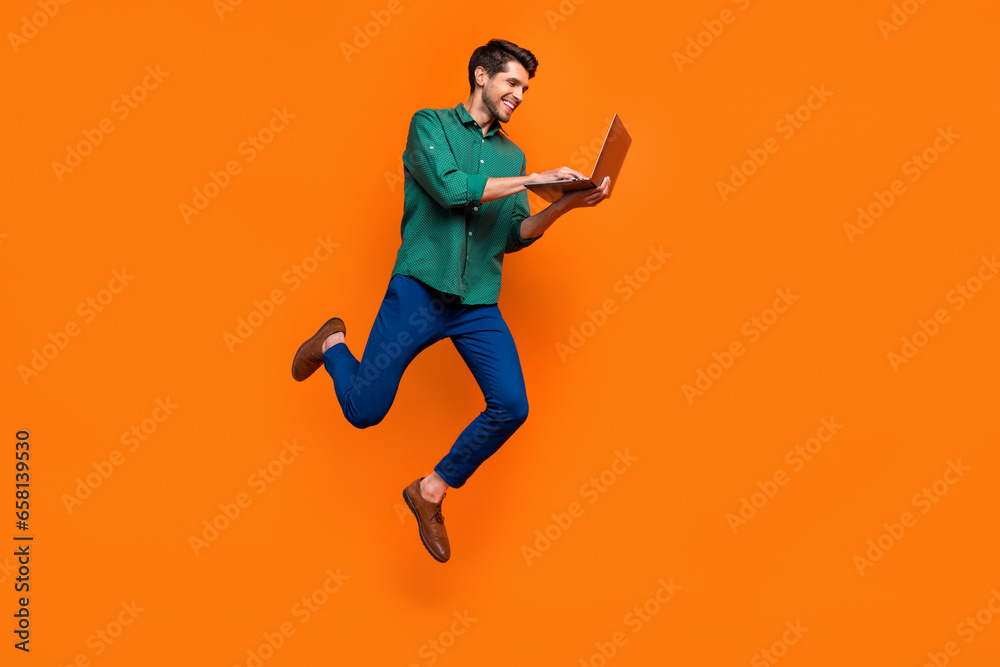 Aufkleber Full length photo of web developer businessman jump netbook user gadget entrepreneur write python code isolated on orange color background