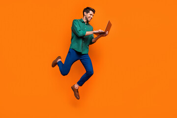 Fototapeta na wymiar Full length photo of web developer businessman jump netbook user gadget entrepreneur write python code isolated on orange color background