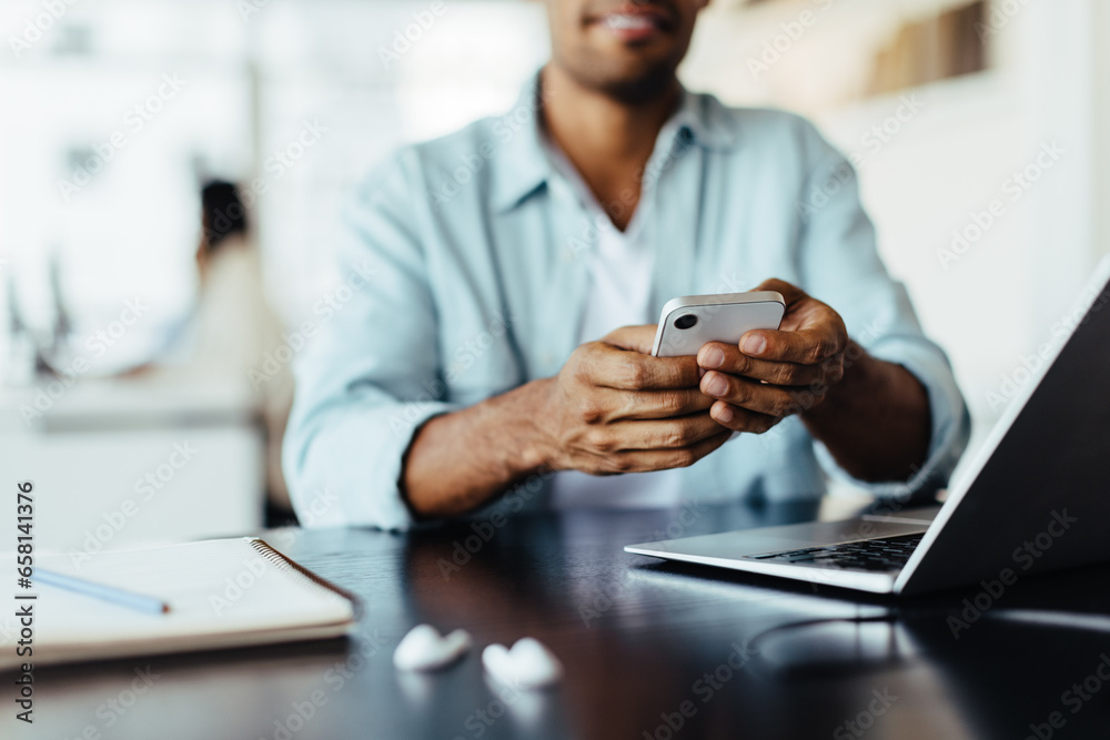 Aufkleber man sitting in an office and using a mobile phone