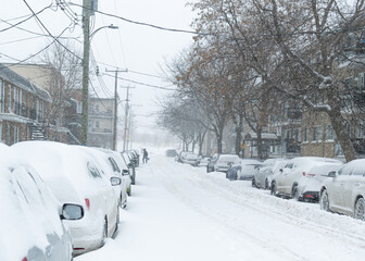 Road under the snow. Urban landscape in winter. City of Montreal under the snow. Winter storm in the city.Car covered with snow.Snow in the city - Snowstorm streetview.Canada,Quebec.