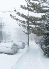 Road under the snow. Urban landscape in winter. City of Montreal under the snow. Winter storm in the city.Car covered with snow.Snow in the city - Snowstorm streetview.Canada,Quebec.