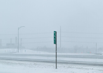 Road under the snow. Urban landscape in winter. City of Montreal under the snow. Winter storm in the city.Car covered with snow.Snow in the city - Snowstorm streetview.Canada,Quebec.
