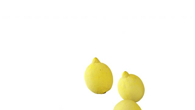Lemons falling down in slow motion on white background.