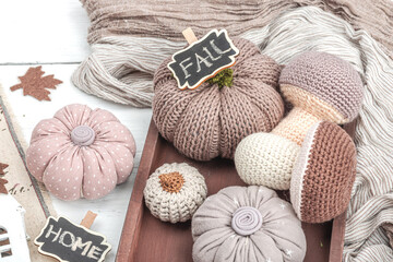 Cozy autumn mood composition. Handmade decor for home, traditional fall symbols - knitted props
