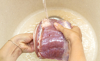 Fototapeta premium Female hands washing meat