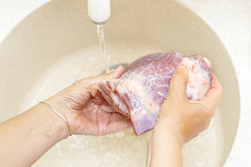 Fototapeta premium Female hands washing meat