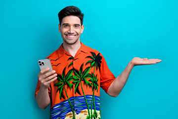 Photo of funny young guy wear shirt hold arm product with iphone summer journey hotel mini bar...