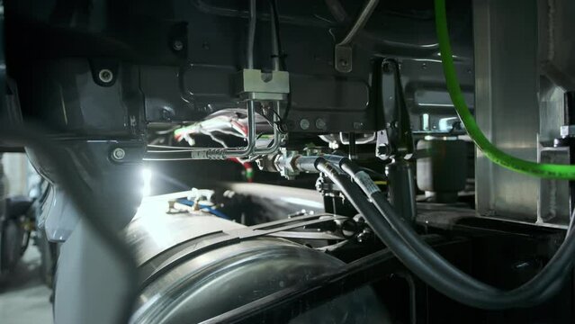 Mechanic man in a work gloves at a lorry service station. Close up shot. move camera