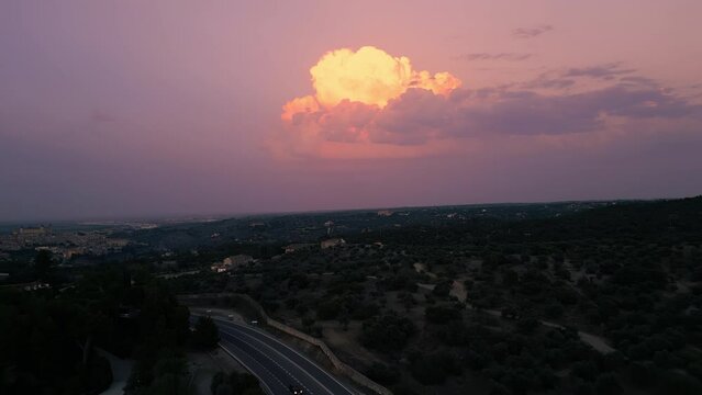Aerial shot of last lights on the cloud painting it in carrot orange color