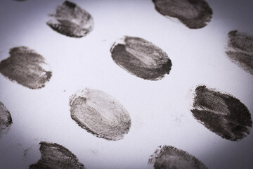 Black fingerprints close-up on a light background