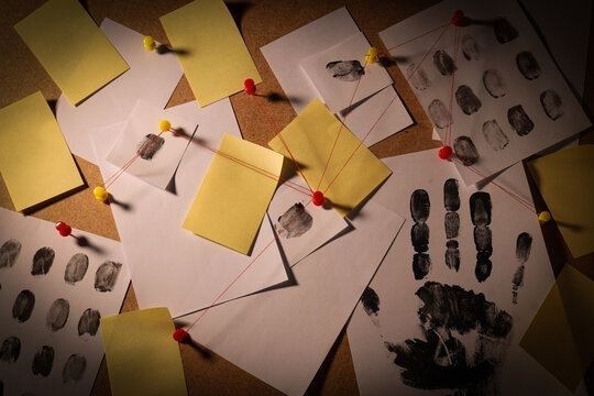 The papers are connected with threads on the board