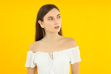 Obraz premium Beautiful emotional girl on a yellow background.