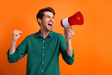 Photo of activist fist up screaming megaphone man workaholic need his salary boss ignore his promotion isolated on orange color background - obrazy, fototapety, plakaty