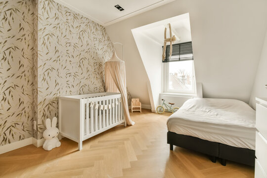 Fototapeta Baby's room with crib and bed and toys
