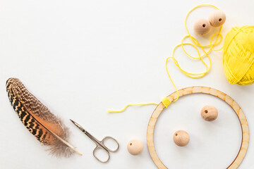Workshop of weaving a dreamcatcher. Wooden ring, deads, threads to make dreamcatcher. Creating...