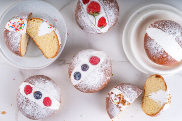 Homemade italian sweet Maritozzi buns, breakfast dessert brioche stuffed with whipped cream, with various topping, nuts, fruit 