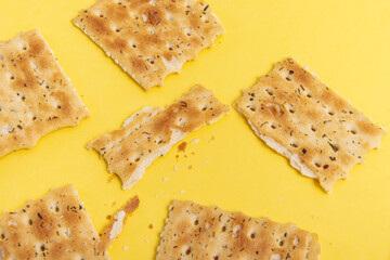Crackers on yellow background. Broken cracker