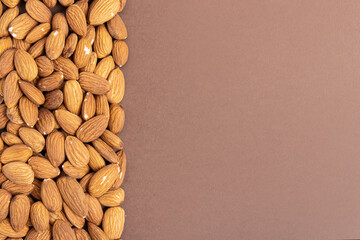 Almond on brown background. Space for text