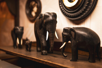 Ebony elephants on a shelf - obrazy, fototapety, plakaty