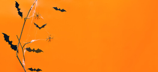 Spooky Halloween Web Banner with Flying Bats, Tree Limbs, and Spiders