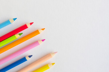Coloured wooden pencils with shadow on a white isolated background. Copy space