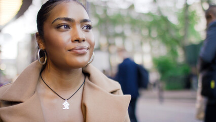 Portrait of attractive young female sitting outside in a cafe thinking to herself, with space for text