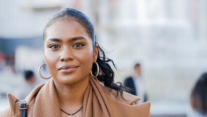Portrait of attractive young female outside looking to camera, with space for text