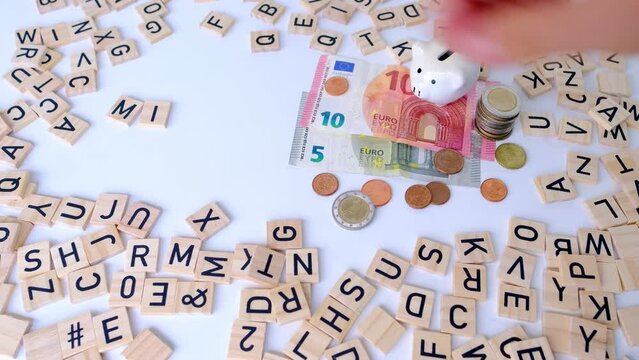 paper euro banknotes, piggy bank, bills on table among euro coins, word Mini job with wood blocks, part-time with low wage concept, marginal employment, help for pension fund, health insurance