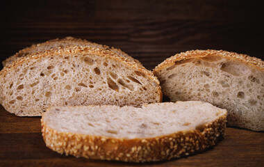 Ciabatta bread. Sliced pieces of bread on a wooden background.