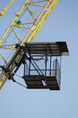 A crane with a cage on the side