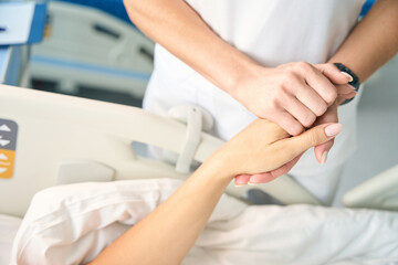 Fototapeta na wymiar Nurse holds the patients hand