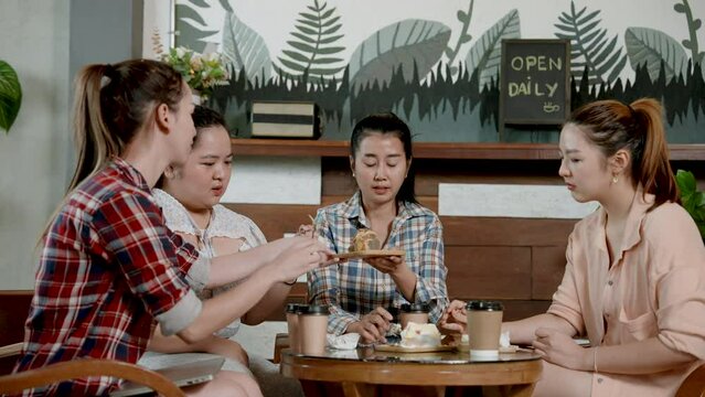 Portrait, long time friend beautiful Asian women, Let's meet at regular cafe on weekends that are free at same time, everyone sat eat delicious cakes, enjoyed chatting with longtime friends.