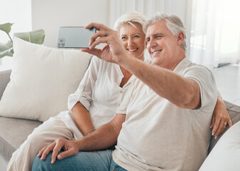 Happy, selfie and old couple on sofa in home, living room or apartment in retirement with post on...