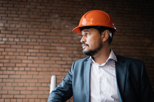 Contemplative engineer standing at construction site