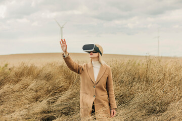 Woman wearing virtual reality simulators gesturing in field