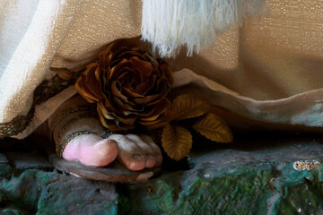 Immaculate Virgin's foot with a golden rose
