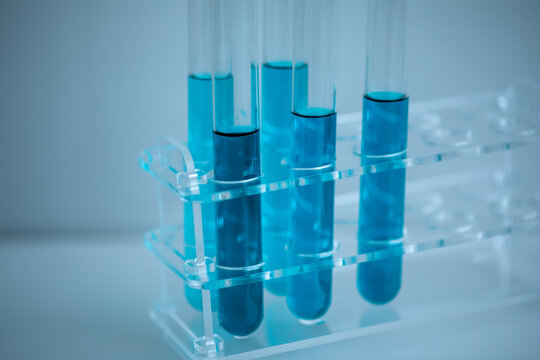 5 Blue Test Tubes Placed In A Medical Tube Rack With A White Background, Close Up, Medical Concept.