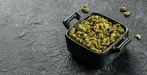spices cardamom pods with seeds. Long banner format. top view